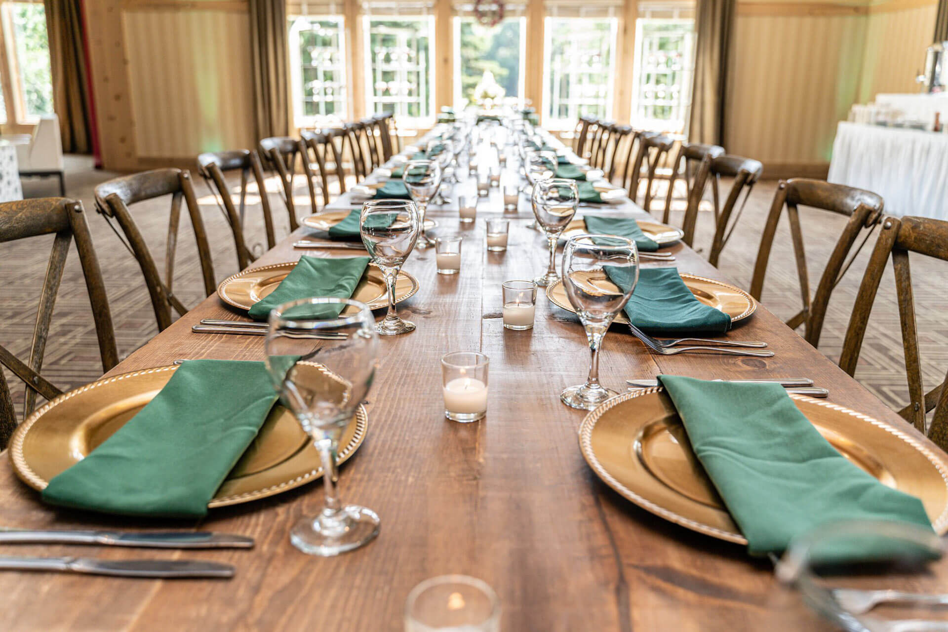 Long dining table with glasses and plates at Bunker Hills Event Center