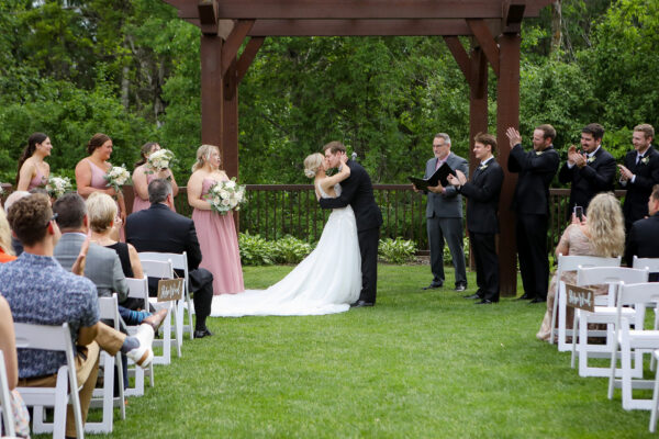 bride and groom posing for photo at the altar