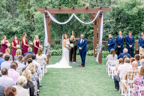 couple and wedding party at the altar