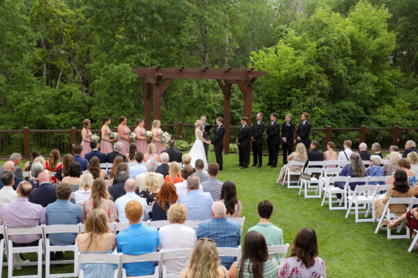 couple, wedding party, and guests assembled for a wedding ceremony