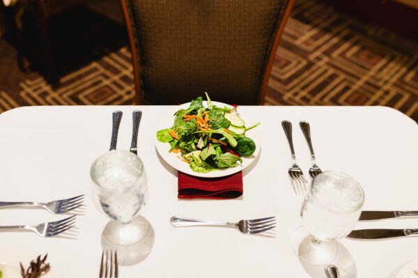 Salad plate on a fully set dinner table
