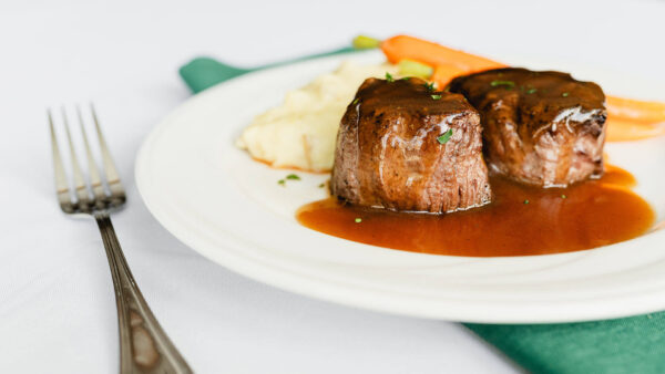 dinner plate of meat, roasted vegetables, and potatoes