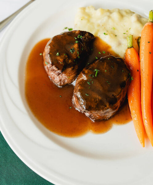 dinner plate of meat, carrots, and potatoes