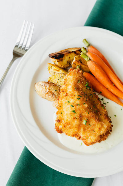 dinner plate of meat, carrots, and potatoes