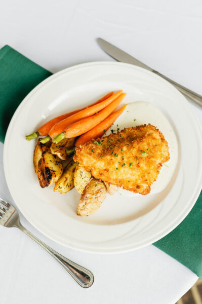dinner plate of meat, carrots, and potatoes