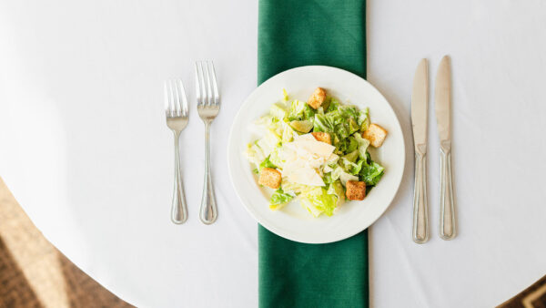 salad plate on a table with silverware and napkin