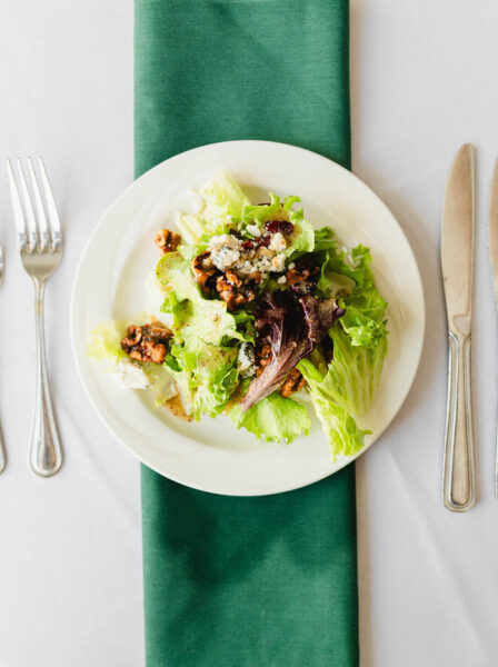 salad plate on a table with silverware and napkin