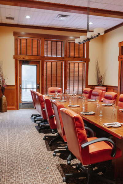 long table with office chairs and fancy glasses