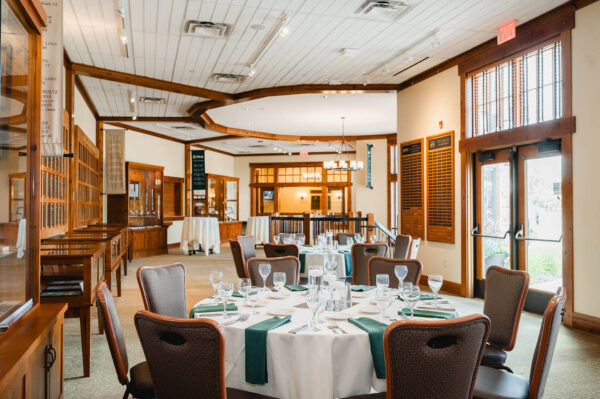 dining tables and chairs set up in the Minnesota Golf Hall of Fame at Bunker Hills Event Center
