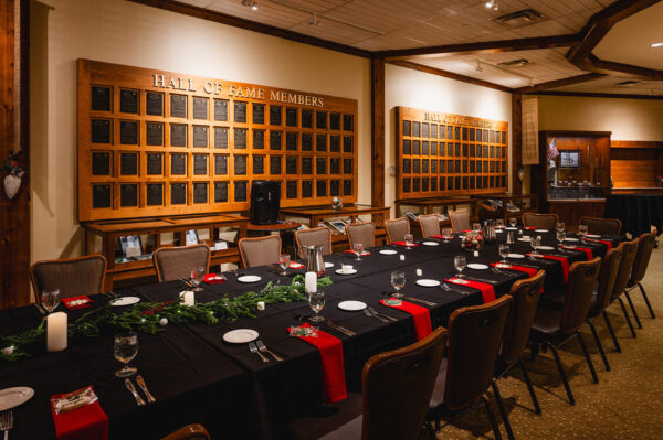 festive dining table and chairs set up in the Minnesota Golf Hall of Fame at Bunker Hills Event Center