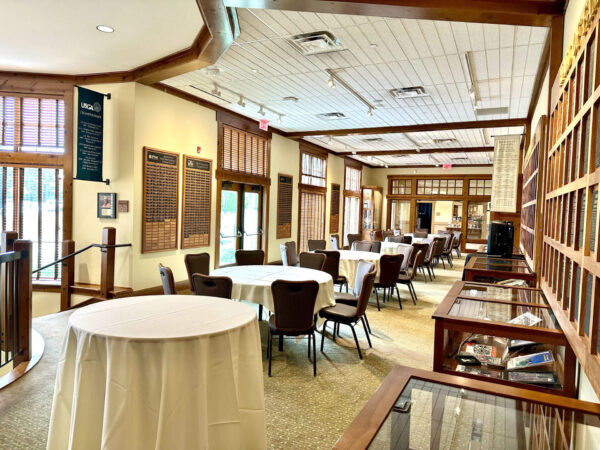 dining tables and chairs set up in the Minnesota Golf Hall of Fame at Bunker Hills Event Center
