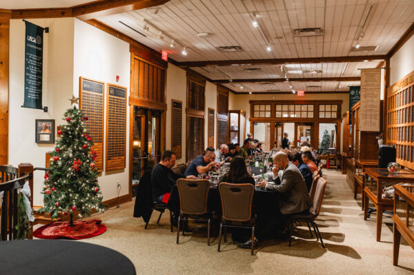 group of people dining at a long festive table