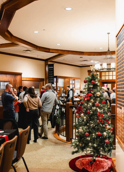 festive tree and group of people talking