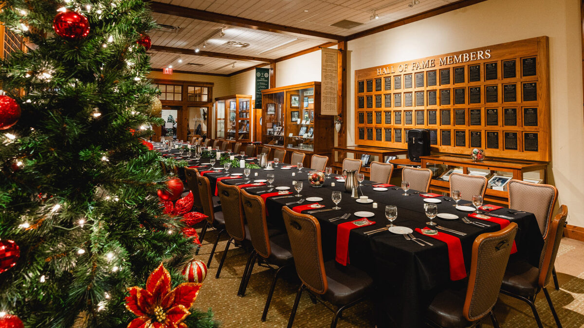 festive dinner table setting and holiday tree