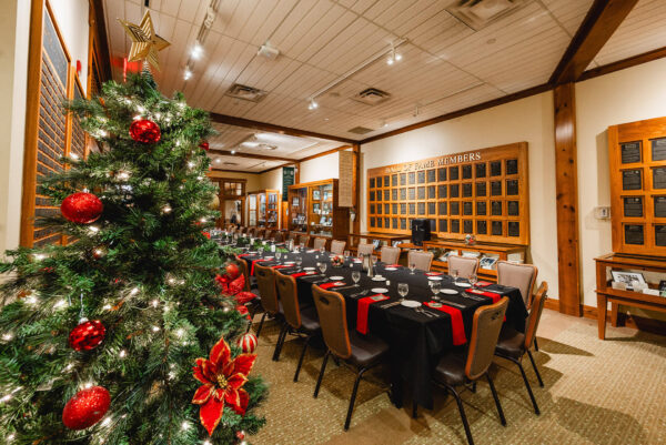 festive dinner table setting and holiday tree