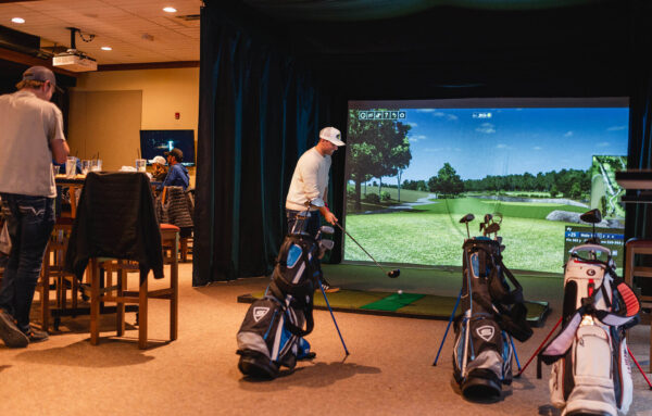 man using golf simulator