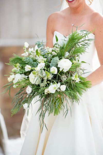bride holding bouquet of white flowers