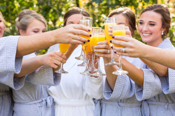 bridesmaids celebrating with colorful drinks