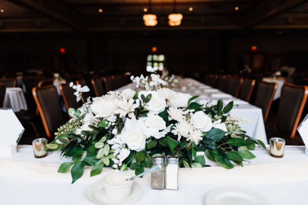 bouquet of white flowers on wedding dinner table