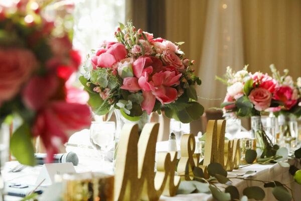 bouquets of pink flowers on wedding dinner table