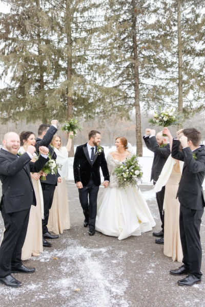 couple and wedding party posing for wedding photos