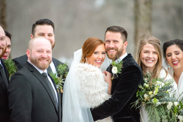 couple and wedding party posing for wedding photos