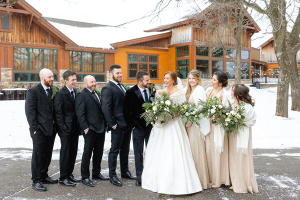 couple and wedding party posing for wedding photos