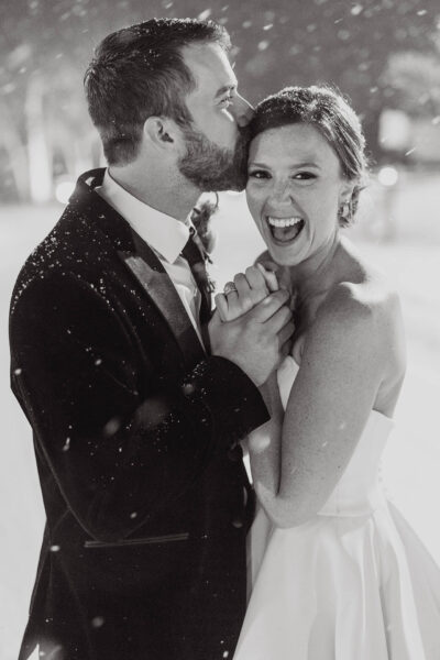 couple posing for wedding photos in snowy landscape