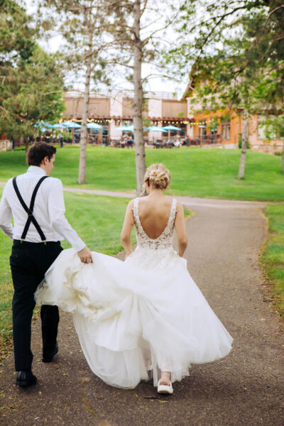 couple walking down a nature path towards celebration