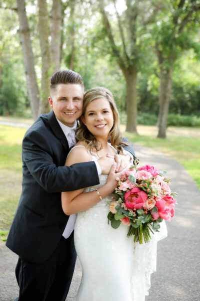 couple posing for wedding photos outdoors