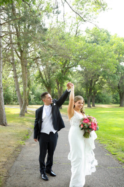 newly wed couple dancing outdoors