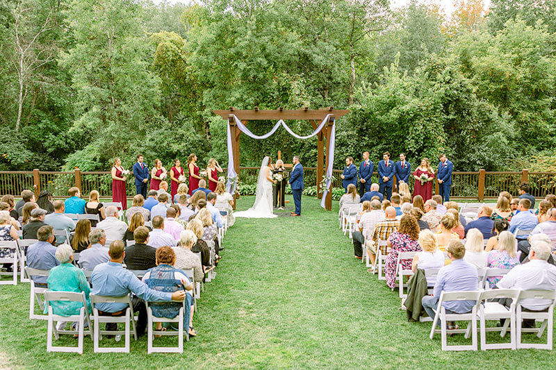 people gathered for an outdoor wedding ceremony at bunker hills